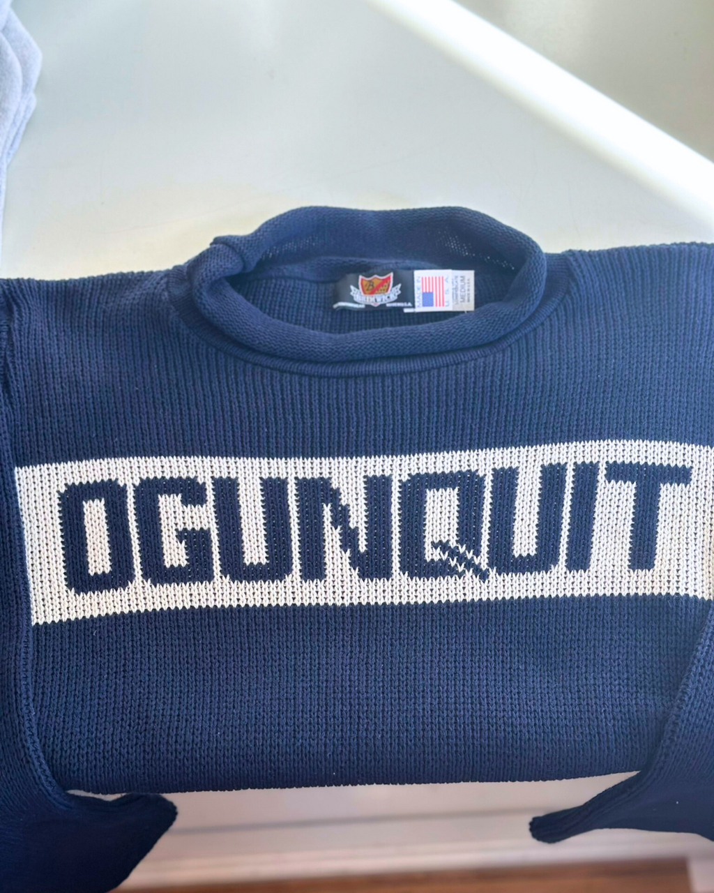 Ogunquit Roll Neck Sweater with bold knit lettering 