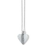 Close-up of silver scroll heart pendant