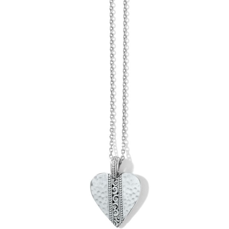 Close-up of silver scroll heart pendant