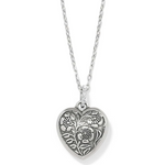 Close-up of silver heart pendant with sparkling sapphire crystals