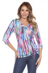Carine Carlie V-neck top with three-quarter sleeves, scrunched drawstring detail on the left hip, and lightweight crinkle fabric with laser burnout, perfect for travel. In the pattern Aurora Flame.