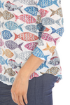 Round-neck top with 3/4 sleeves, contrast stitching, and a curved hem for a flattering fit. Made from lightweight burnout crinkle fabric, perfect for travel. In Pattern Fish.