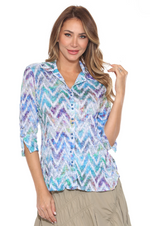 Sabrina Shirt with snap-button front, faux sleeve ties, and curved hem—lightweight and versatile travel top for women. In the pattern Chevron Haze.