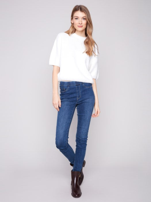 Model styling knit sweater with jeans for a casual fall look