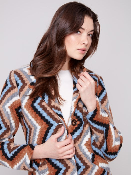 Close-up of crochet texture and button closure on Charlie B Long Coat