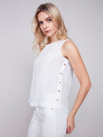 Side detail view of Charlie B linen top with decorative buttons in white
