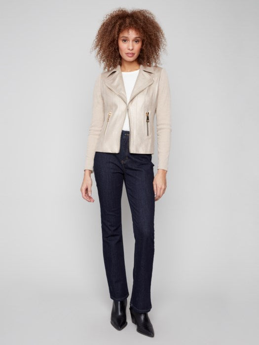 Model wearing metallic faux leather jacket styled with denim