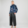 Model wearing soft turtleneck sweater with floral sketch print