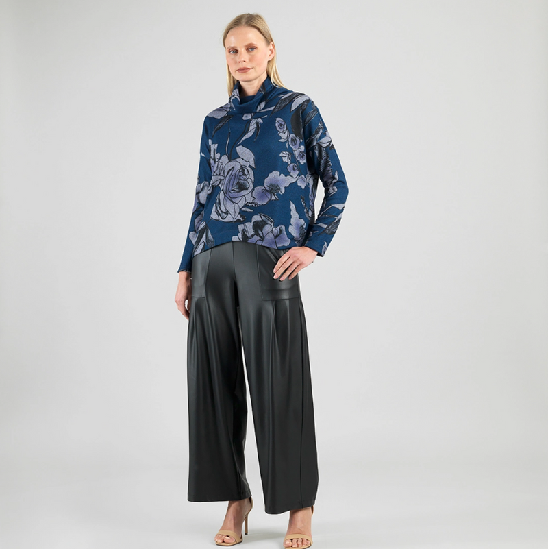 Model wearing soft turtleneck sweater with floral sketch print