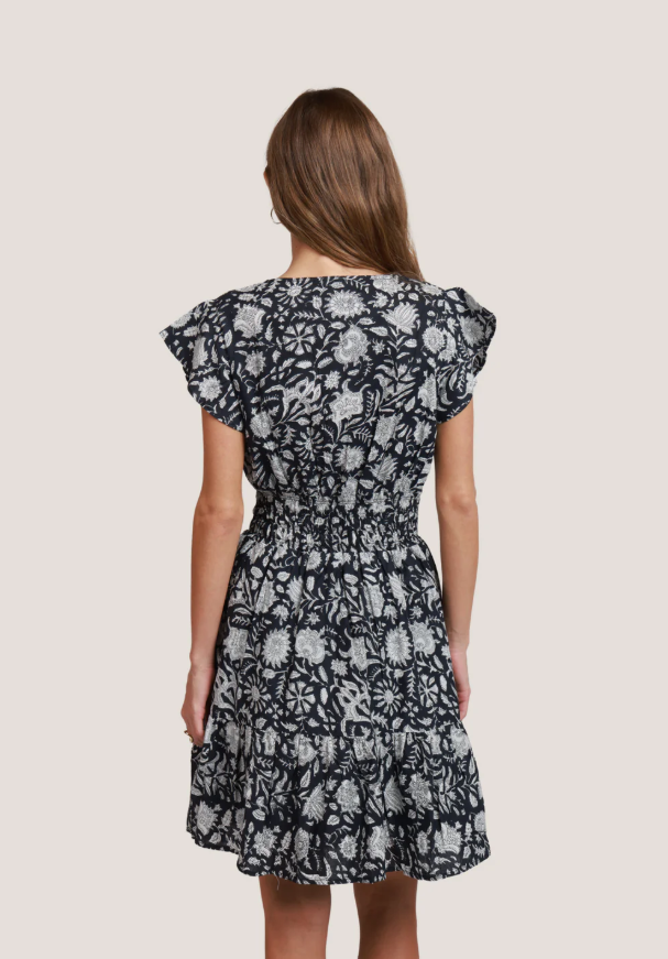 Back view of Magnolia Day Dress with flowing skirt and soft floral print
