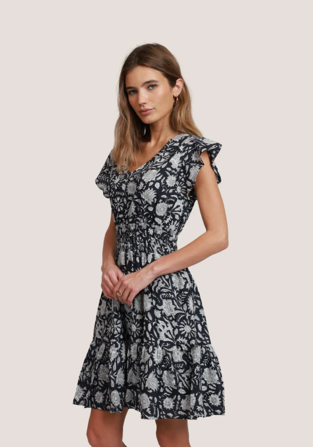 Side view of tiered A-line cotton dress with flutter sleeves