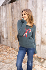 Cozy holiday sweater styled with knit candy canes, available at The Lazy Daisy