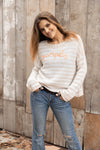 Front view of Pumpkin Striped Crew with “Pumpkin” embroidered on stripes
