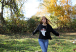 Close-up of chunky knit ghost design on boxy crewneck sweater