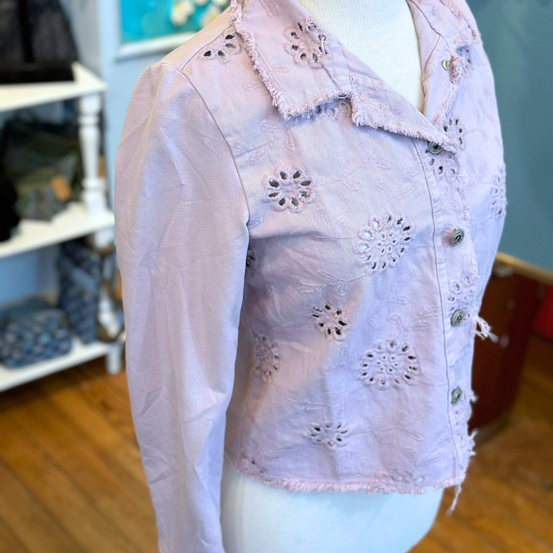 Femme Fatale Embroidered Eyelet Jacket – Women's cropped spring jacket with button front, eyelet embroidery, frayed edges, and soft stretch jersey sleeves and back. Stylish and versatile layering piece. In the color Dusty Rose.