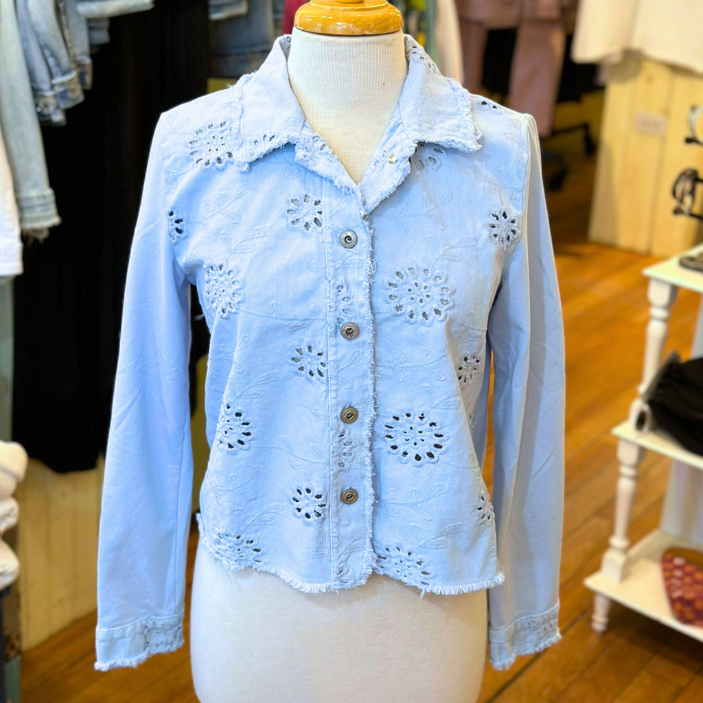 Femme Fatale Embroidered Eyelet Jacket – Women's cropped spring jacket with button front, eyelet embroidery, frayed edges, and soft stretch jersey sleeves and back. Stylish and versatile layering piece. In the color Ice.