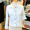 Femme Fatale Embroidered Eyelet Jacket – Women's cropped spring jacket with button front, eyelet embroidery, frayed edges, and soft stretch jersey sleeves and back. Stylish and versatile layering piece. In the color White.