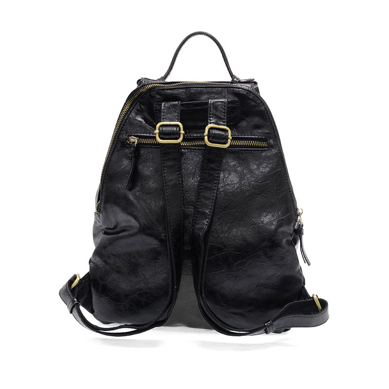 Maggie Modern Backpack in distressed vegan leather with adjustable straps.