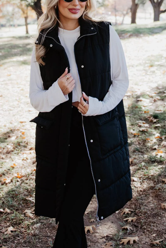 Black long quilted puffer vest with button and zipper closure
