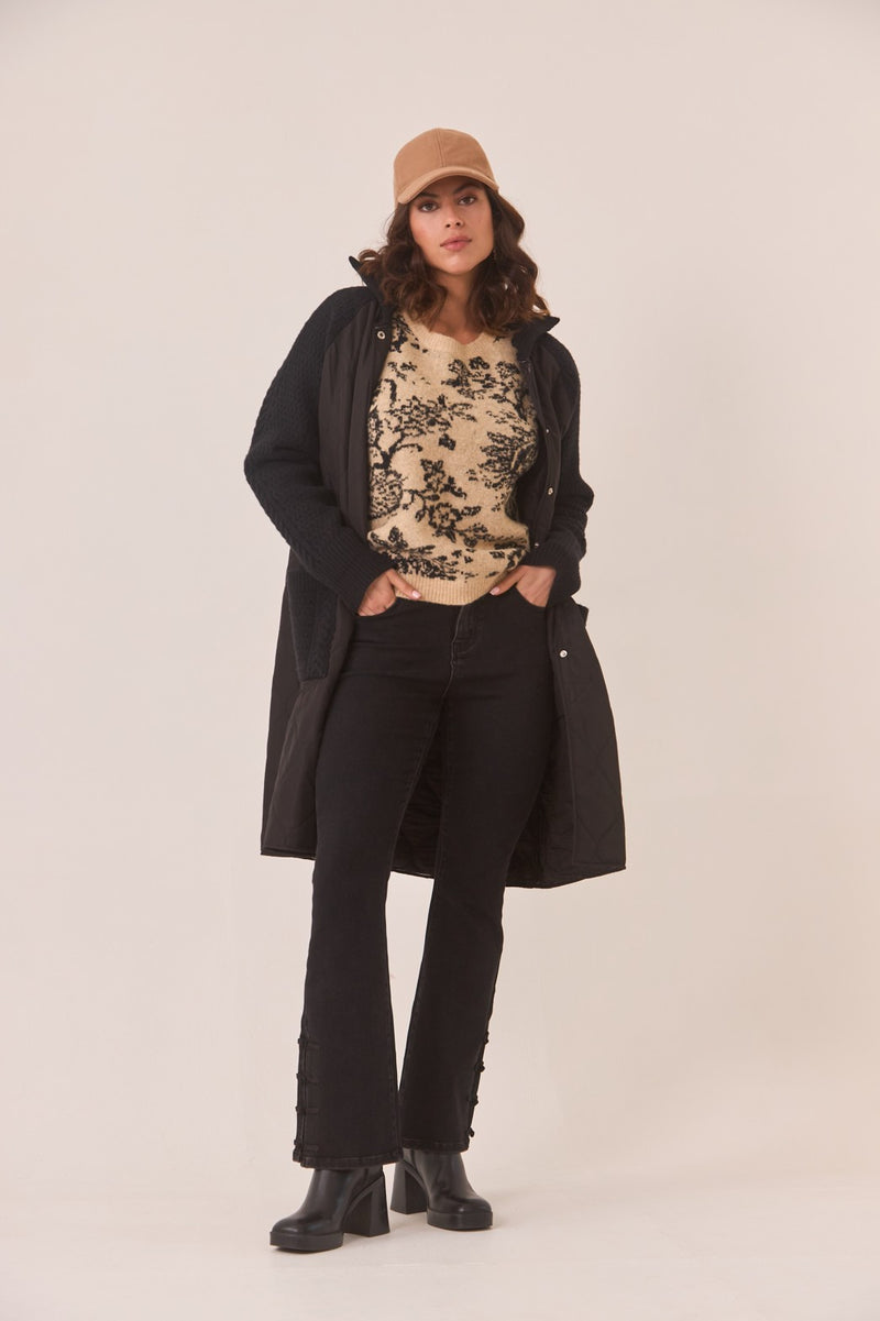 Camel and black floral patterned sweater styled for layering