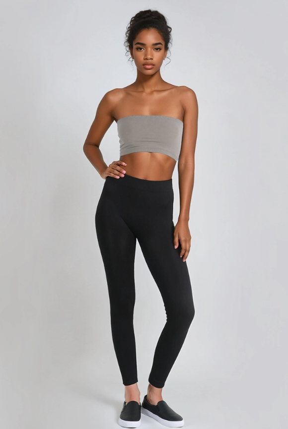 Full-length view of soft Nikibiki ankle leggings in the color black on model