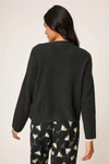 Women’s black snuggle knit sweater with “Merrier with a Martini” graphic.