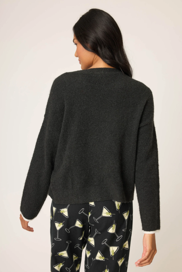 Women’s black snuggle knit sweater with “Merrier with a Martini” graphic.