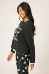Long-sleeve women’s cozy black sweater with holiday slogan.