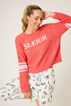 Women’s red fuzzy knit pullover with “Sleigh” graphic and striped sleeves.
