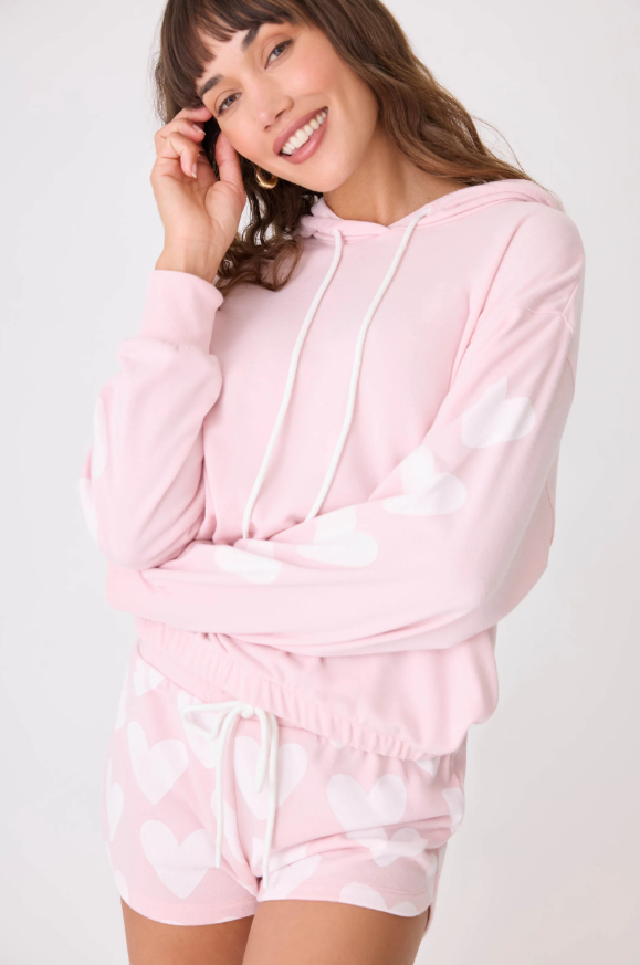 Model wearing pink PJ Salvage hoodie with drawstring hood