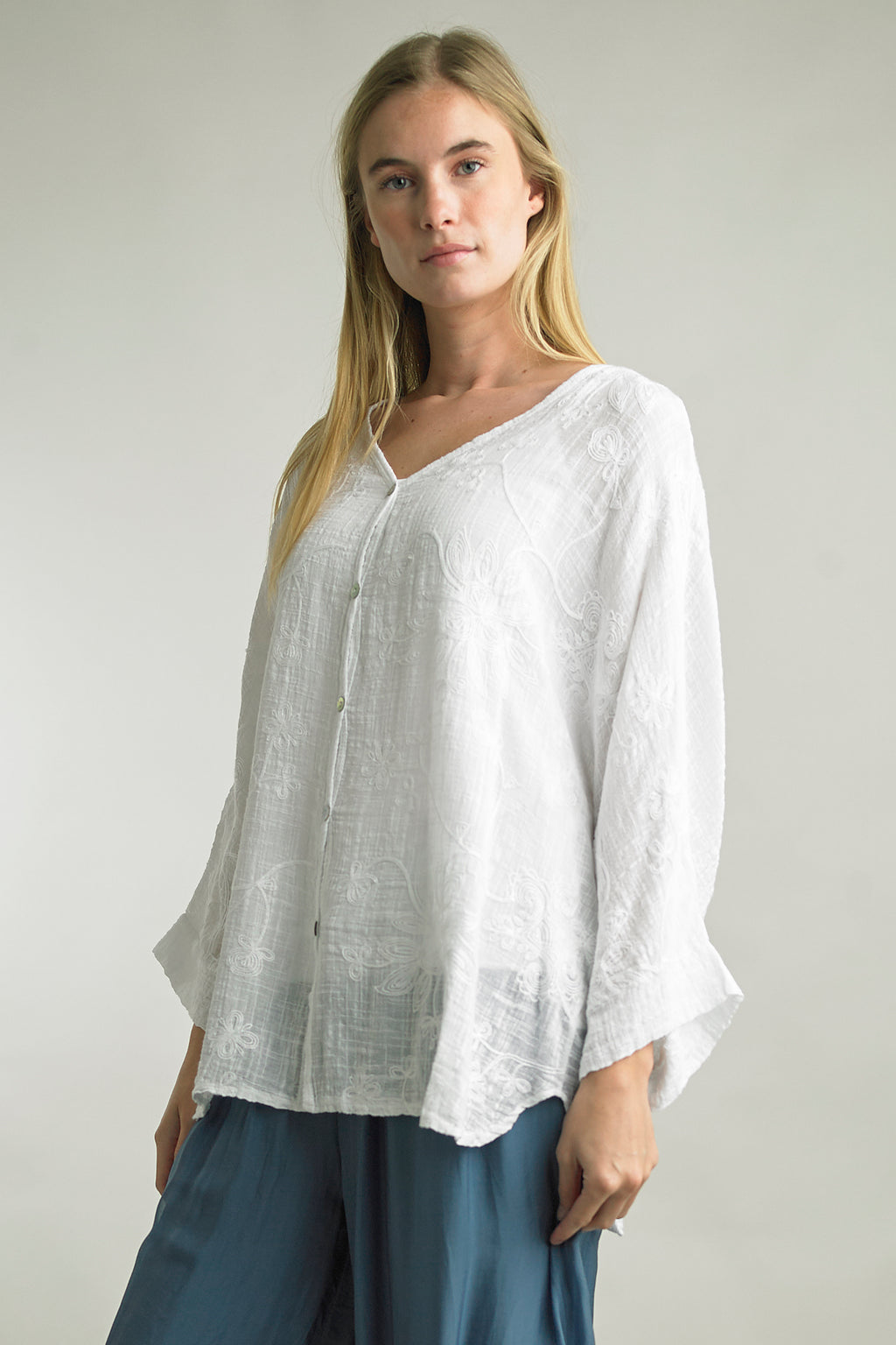 Model wearing Tempo Paris embroidered button-up cotton blouse in White