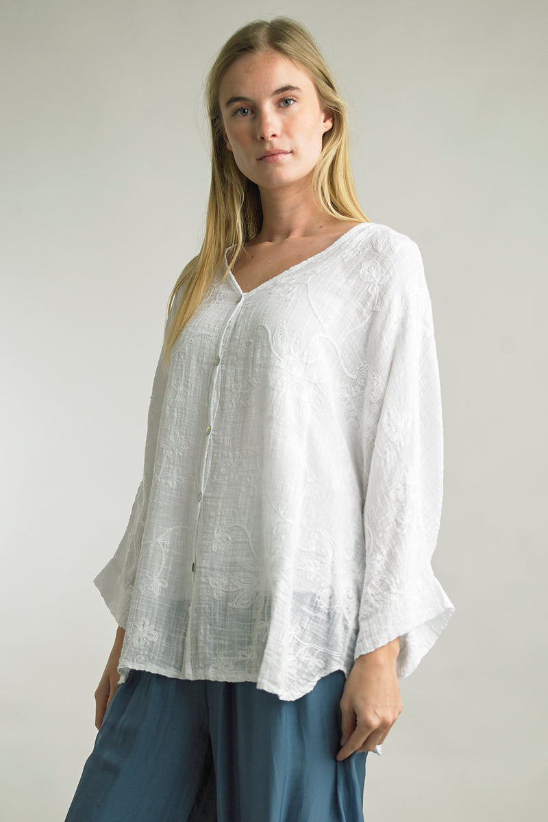 Model wearing lightweight Italian cotton button-up with floral details in White