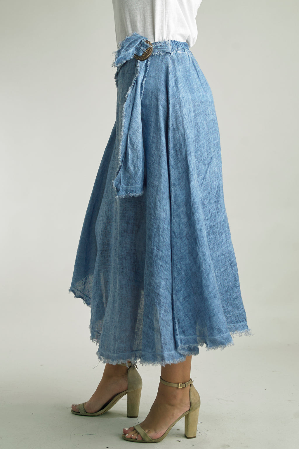 Asymmetrical midi skirt with frayed hem and wrap waist in the color Denim