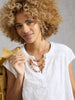 Lightweight embroidered women’s top styled for warm weather in the color white at The Lazy Daisy