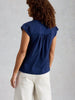 Short sleeve cotton top with feminine embroidery detail in the color Indigo Blue at The Lazy Daisy