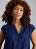 Lightweight embroidered women’s top styled for warm weather in the color Indigo Blue at The Lazy Daisy