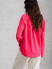 Relaxed fit women’s button-front cotton shirt in the color Bright Pink at The Lazy Daisy