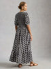 Feminine midi dress with shirred top and flowing skirt at The Lazy Daisy