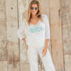 Model wearing Beach Arrow sweater over swimwear