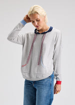 Front view of knit hoodie with kangaroo pouch and contrast cuffs