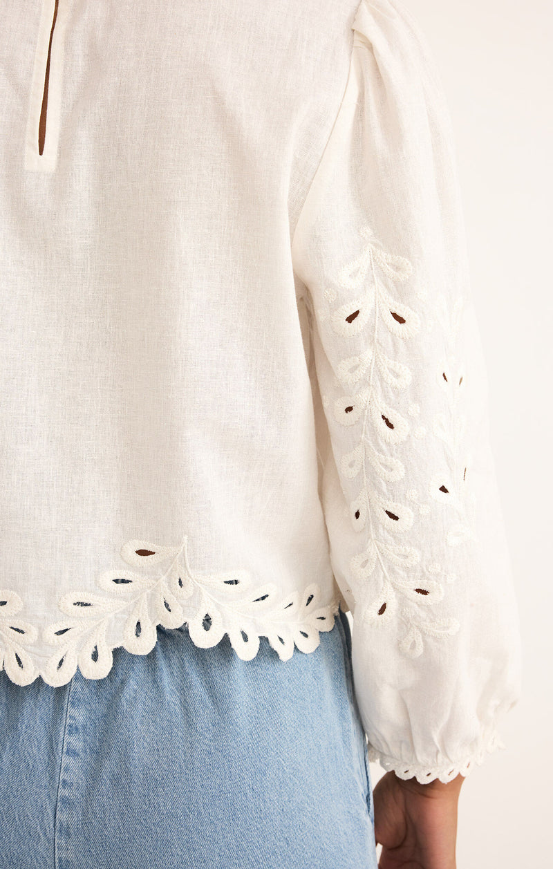 Close-up of eyelet embroidery on the Ambirose Top – nature-inspired white cotton blouse with scalloped detailing