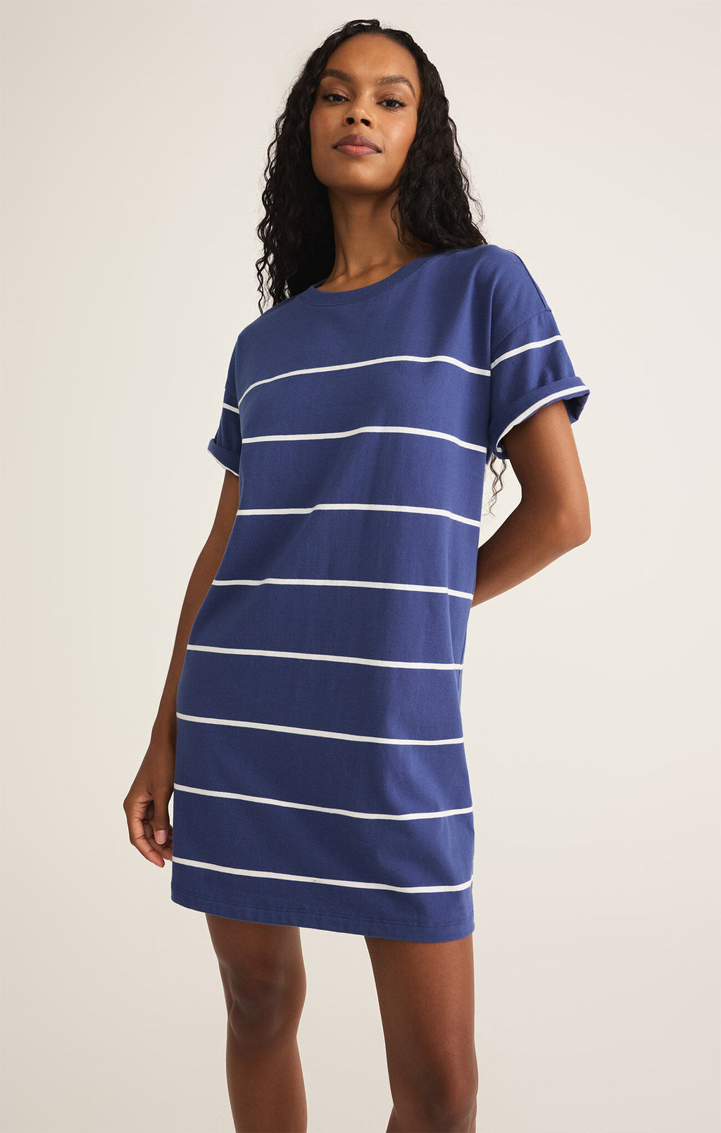 Model wearing the Sway Stripe Mini Dress with coastal stripes and crew neckline
