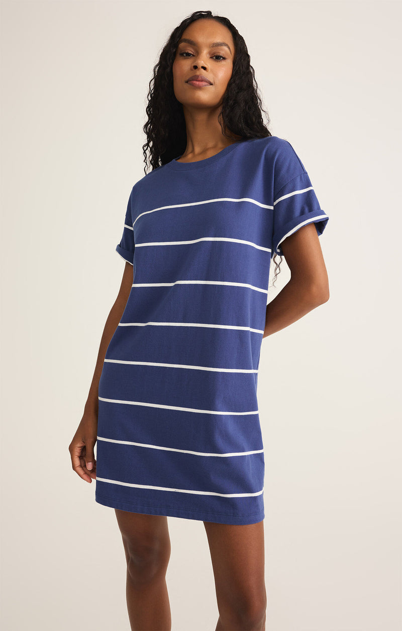 Model wearing the Sway Stripe Mini Dress with coastal stripes and crew neckline