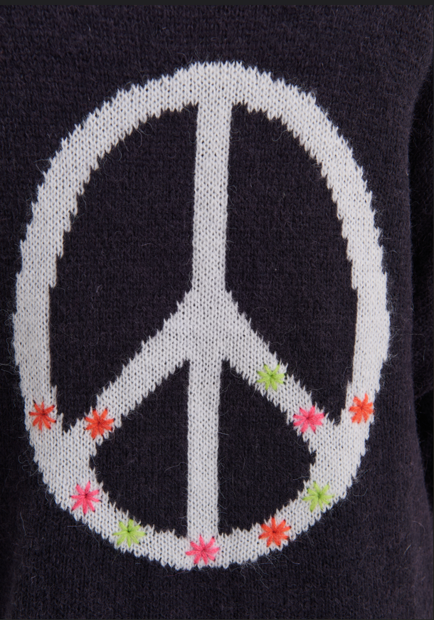 Back view of Zaket & Plover Lofty Peace Cardi with white peace symbol and colorful accents
