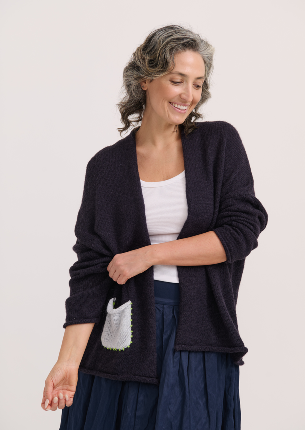 Front view of Zaket & Plover Lofty Peace Cardi with light gray pocket and lime green stitching