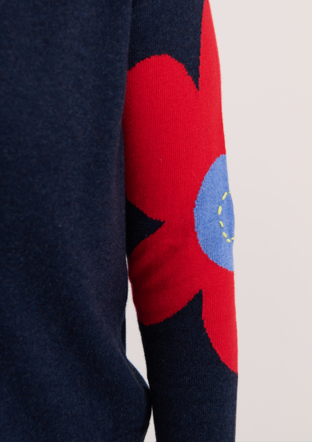 Sleeve close-up with flower and peace sign embroidery