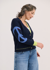Sleeve close-up with flower and peace sign embroidery