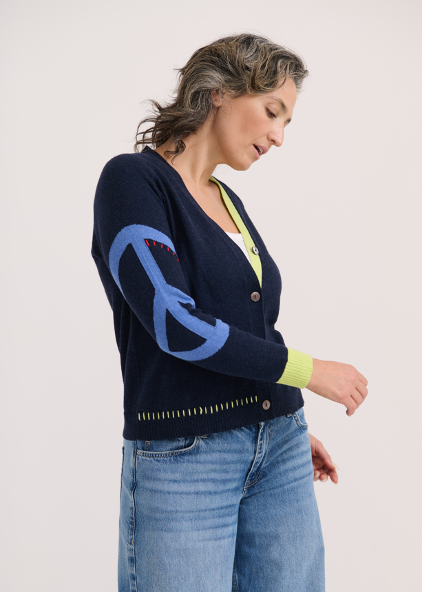 Sleeve close-up with flower and peace sign embroidery