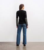 Cozy knit sweater with striped-to-solid sleeve transition and embroidery
