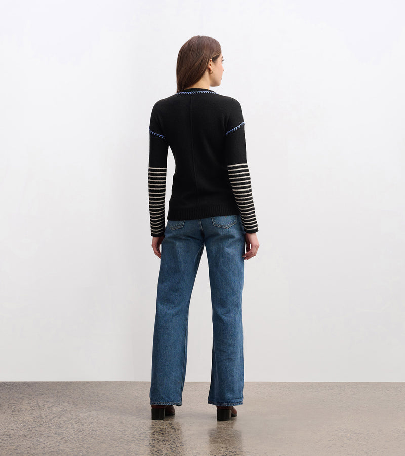 Cozy knit sweater with striped-to-solid sleeve transition and embroidery